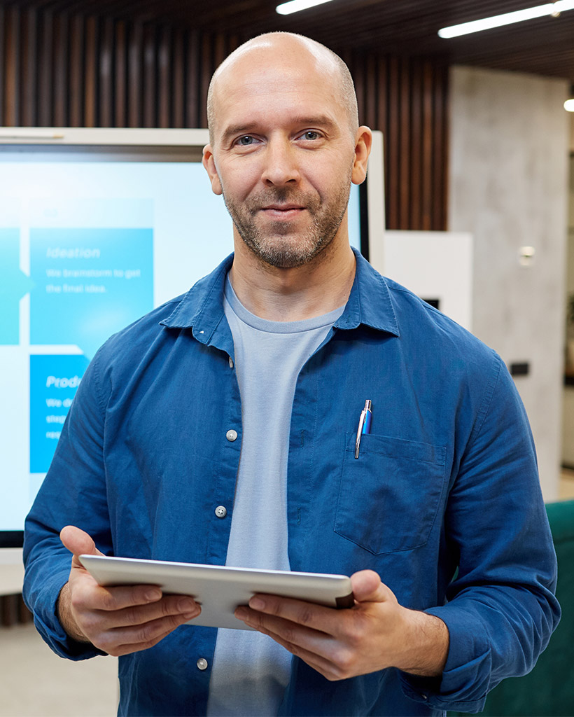modern bald manager standing at digital board PMVSWNF